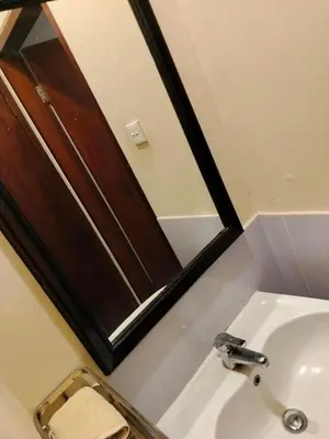 a bathroom with a sink and a mirror at Villa Layang Bulan a homey guesthouse for men near the beach in North Kuta in Denpasar