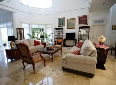 a living room with a couch and a table at Guildwood Villa Bali in Sanur