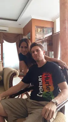 a man and a woman sitting in a chair at Guildwood Villa Bali in Sanur