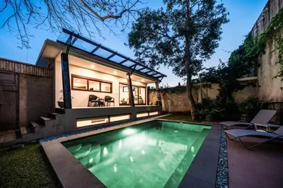 a small swimming pool in front of a house at Jado 1 Unique Cinema Entertainment Villa in Umalas in Kerobokan