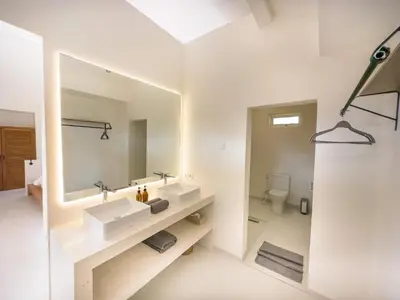 a bathroom with two sinks and a mirror at Stylish 2bdr poolvilla Centre Seminyak in Seminyak
