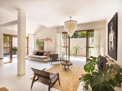 a living room with a couch and a table at Stylish 2bdr poolvilla Centre Seminyak in Seminyak