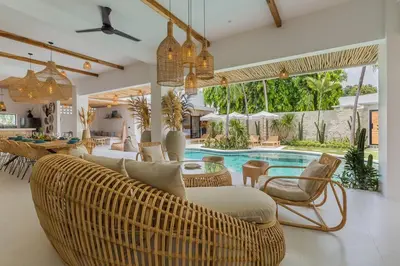 a living room with wicker furniture and a swimming pool at Villa Kiara our Paradise in Seminyak 5 bedrooms 12m private pool in Seminyak