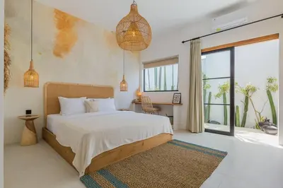a bedroom with a bed and a large window at Villa Kiara our Paradise in Seminyak 5 bedrooms 12m private pool in Seminyak