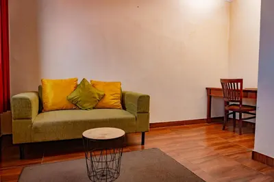 a living room with a couch and a table at Puri Dibia Kuta Hotel & Apartment in Kuta
