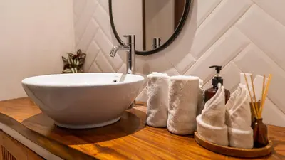 a bathroom with a bowl sink on a wooden counter at An Amazing 6BDR Private Family Villa with Pool in Tanah Lot