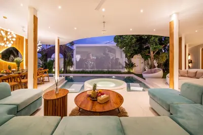 a living room filled with furniture and a swimming pool at Magic Mango Villa Huge Projector bubble bath unique design in Canggu