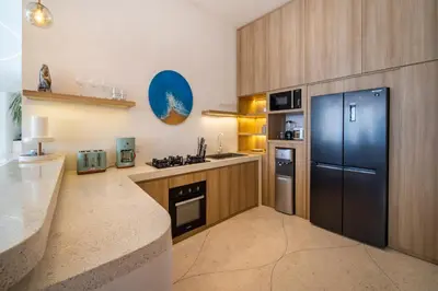 a kitchen with a refrigerator and a counter top at Magic Mango Villa Huge Projector bubble bath unique design in Canggu