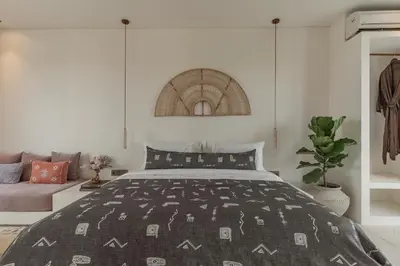 a bedroom with a bed and a couch at The Revery Bali in Canggu