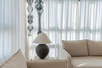 a lamp sitting on a table next to a couch at The Revery Bali in Canggu