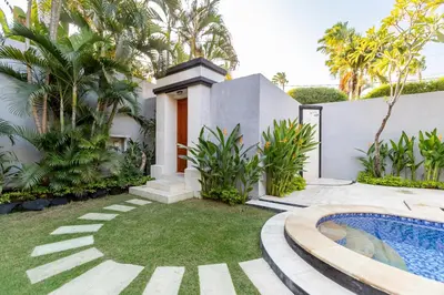 a house with a swimming pool and a yard at Viona 3 Villa - 3 BDR villa, walk to the beach in Seminyak