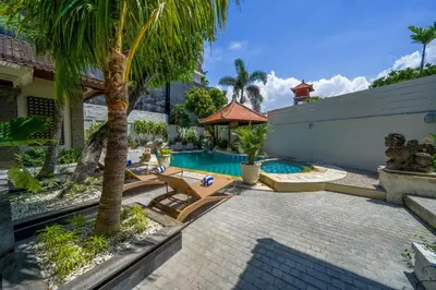 a backyard with a pool and a palm tree at Villa CHANDI 1 - Legian-Seminyak - 8 Bedroom - 7 Bathroom Villa in Seminyak