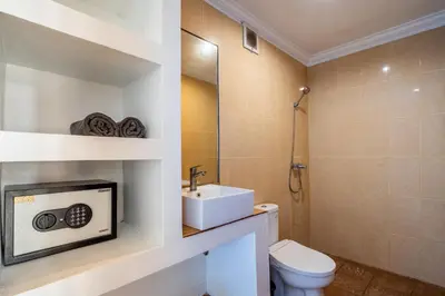 a bathroom with a white toilet and a sink at Lumturi House - Centrally Located in Seminyak