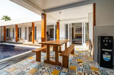 a wooden table and bench in a house at Lumturi House - Centrally Located in Seminyak