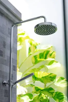 a shower head with a plant in the background at Villa Ley Hidden Gem Villa 1 Bedroom Private Pool Seminyak in Seminyak