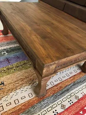a wooden coffee table sitting on top of a rug at Villa Lina, Nusa Dua Benoa in Nusa Dua