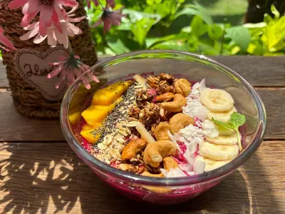 a bowl of food sitting on a wooden table at Villa Lina, Nusa Dua Benoa in Nusa Dua