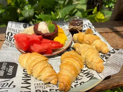 a plate of pastries and fruit on a table at Villa Lina, Nusa Dua Benoa in Nusa Dua