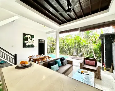 a living room with a couch and a table at Casa Sessy Legian in Seminyak