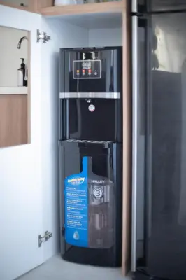 a refrigerator in a kitchen with a box next to it at Casa Z - Seminyak 3BR Villa with Private Pool in Seminyak