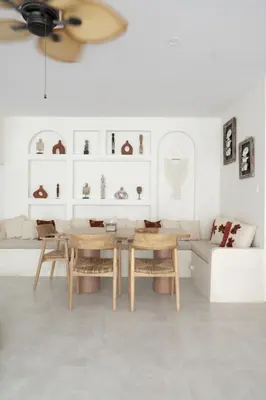 a living room with a table and chairs and a couch at Casa Z - Seminyak 3BR Villa with Private Pool in Seminyak
