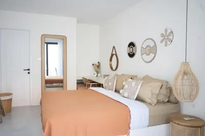 a bedroom with a bed and a mirror at Casa Z - Seminyak 3BR Villa with Private Pool in Seminyak