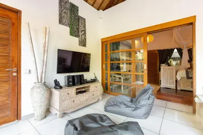 a living room with a tv and a couch at Luxurious Double King Villa w/Pool & WiFi+ Carpark in Seminyak