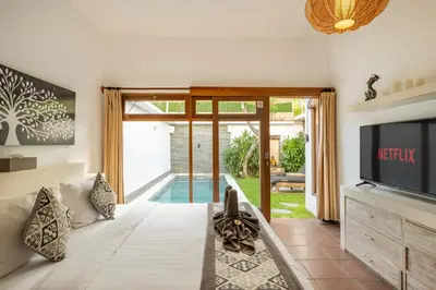 a living room with a couch and a tv at 2 Br Villa in Seminyak with private Pool and Parking in Seminyak
