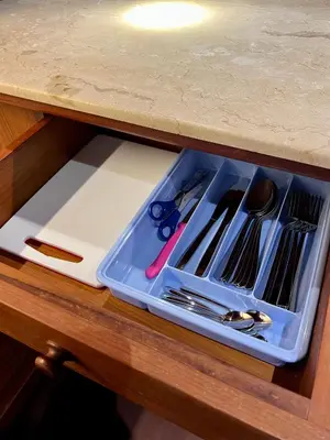 a plastic tray with utensils in a drawer at Galayanee’s Resort Apartment in Seminyak