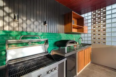 a kitchen with a stove and a sink at Villa Mahkota Seminyak in Seminyak