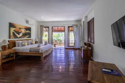 a bedroom with a bed and a television in a room at Enclose living 5Br Villa Center of Seminyak Near Beach in Seminyak