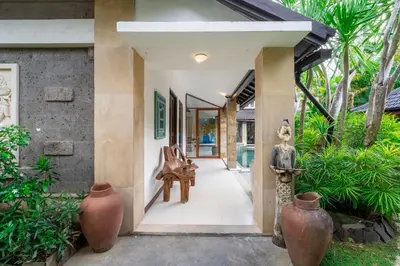 an entry way to a house with vases at Enclose living 5Br Villa Center of Seminyak Near Beach in Seminyak