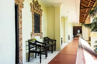 a hallway with chairs and a table on a house at SANJAYA HOTEL in Legian
