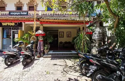 a group of motorcycles parked in front of a building at SANJAYA HOTEL in Legian