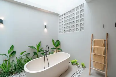 a bath tub in a bathroom with plants at Villa LouLou Bali - Brand New Tropical 3BR Villa Next to Canggu in Canggu