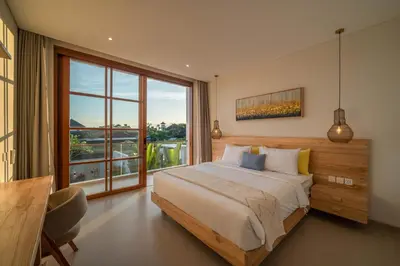 a bedroom with a bed and a large window at Villa LouLou Bali - Brand New Tropical 3BR Villa Next to Canggu in Canggu