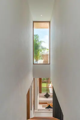 a staircase leading to the second floor of a house with a window at Villa LouLou Bali - Brand New Tropical 3BR Villa Next to Canggu in Canggu