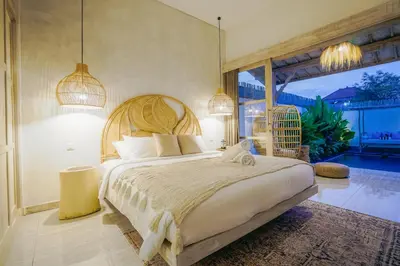 a bedroom with a large bed and a large window at Villa Aarka - Chic Balinese Bohemian Retreat in Seminyak in Seminyak
