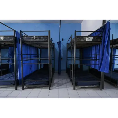two bunk beds in a room with blue walls at Bunk Bed Bali near Sanur Mitra RedDoorz in Pesanggaran