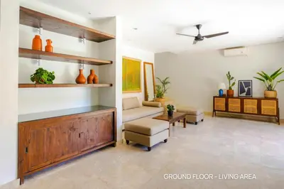 a living room with a couch and a table at Villa Palm Suites Bali in Seminyak