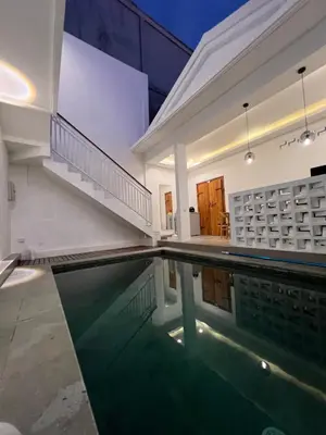 a house with a swimming pool in the middle of it at Villa Carik by Globalstay - Kerobokan x Seminyak x Canggu in Kerobokan