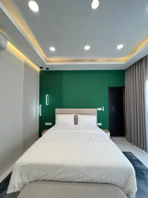 a bedroom with a large bed with a green wall at Villa Carik by Globalstay - Kerobokan x Seminyak x Canggu in Kerobokan