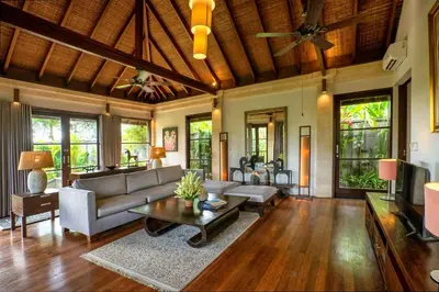 a living room with a couch and a table at Villa Pulung Jimbaran by Nakula in Jimbaran