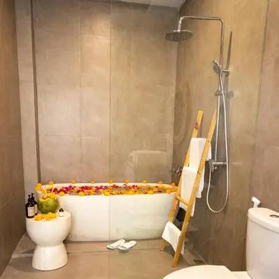 a bathroom with a bathtub with flowers on it at Balibay 1 - Private Villa with Pool in Canggu in Kerobokan