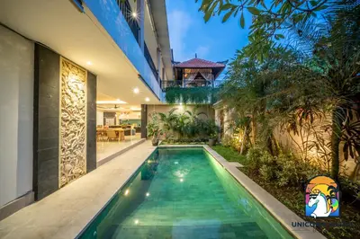 an indoor swimming pool in the middle of a house at Rumah Senang - by Unicorn Villas Bali in Seminyak