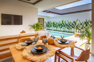 a living room with a table and a pool at Balibay 2 - Best Place by the Beach in Canggu in Kerobokan