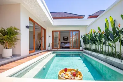 a swimming pool in a villa with a house at Balibay 2 - Best Place by the Beach in Canggu in Kerobokan
