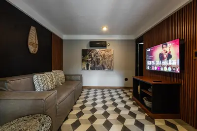 a living room with a couch and a flat screen tv at Villa Zazu in Seminyak
