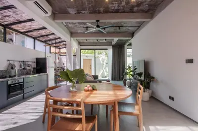 a kitchen and dining room with a wooden table and chairs at Sasa's Villa Seminyak in Seminyak
