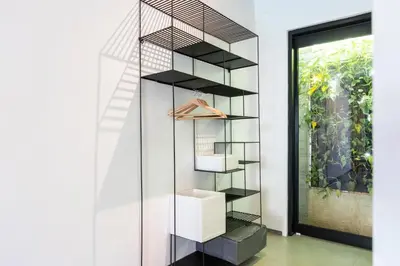 a book shelf in a room with a window at Sasa's Villa Seminyak in Seminyak